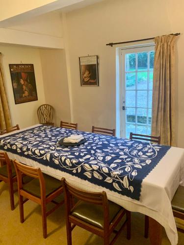 a bedroom with a table and chairs and a window at Bell Tower in Hereford