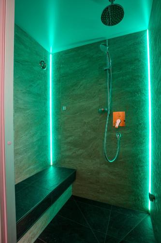 a bathroom with a shower with green lights at Haus Saskia in Sölden