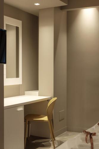a desk and a chair in a room at Il Casato Deluxe Rooms in Scilla