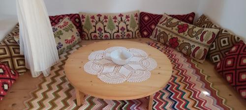a table with a bowl on top of a bed with pillows at Traditional house in Asfendiou in Kos Town