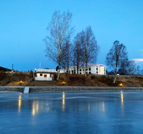 a hockey rink with a building in the background at Hurdalsjøen Hotel in Hurdal