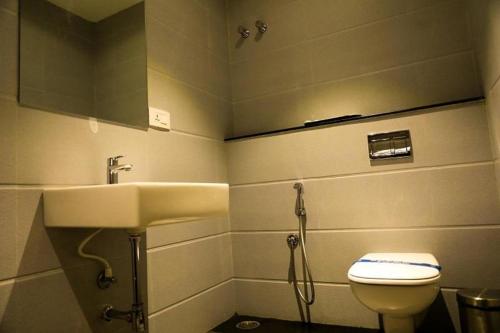 a bathroom with a sink and a toilet at Laya Regency in Mayiladuthurai