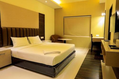a bedroom with a bed and a desk and a chalkboard at Laya Regency in Mayiladuthurai