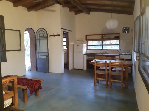 een keuken en eetkamer met een tafel en stoelen bij La Roja y Barro tal vez in Los Molles