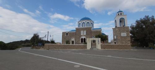 a brick building with two towers on a road at Traditional house in Asfendiou in Kos Town