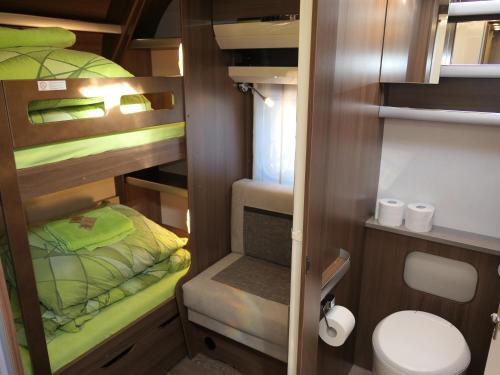 a small room with a bed and a toilet at Kamping u Łukasza in Zakopane