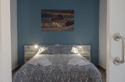 sypialnia z łóżkiem z niebieską ścianą w obiekcie V.V. Casa Quintero w mieście Tigaday