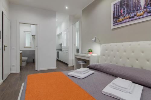 a bedroom with a bed with two towels on it at Malta Guest House in Piacenza