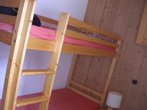 a bunk bed in a room with two bunk beds at appartement F2 in La Plagne Tarentaise