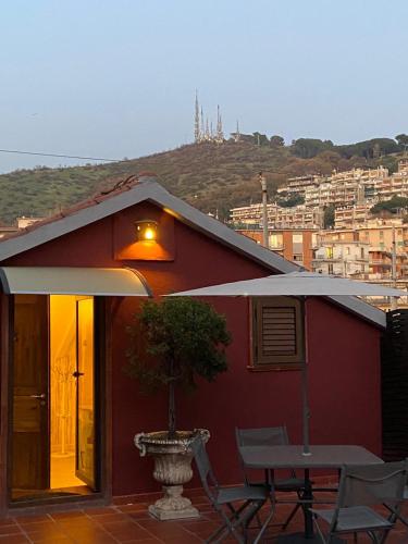 a red house with a table and chairs on a patio at B&B Mini Hotel Incity-close train station and port- in Salerno