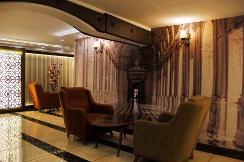a lobby with chairs and a table in a building at Marmara Place Old City Hotel in Istanbul