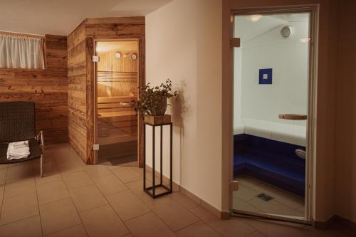 a bathroom with a bed and a glass door at Haus Mischabel in Zermatt