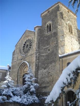 a building with a clock tower with snow on it at Castello di Altomonte in Altomonte