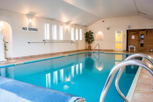 a swimming pool with a no diving sign on the wall at Beachlands Hotel in Weston-super-Mare