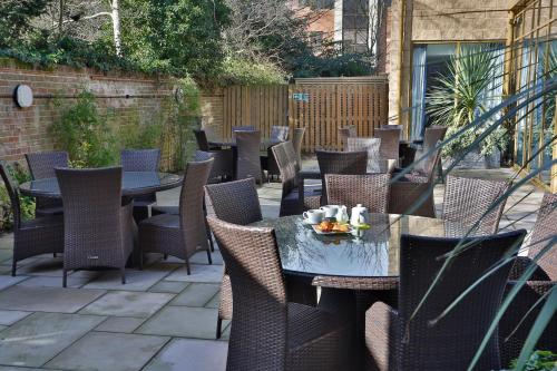 an outdoor patio with tables and chairs at Holiday Inn Express Windsor by IHG in Windsor