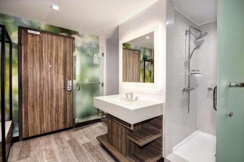 a bathroom with a sink and a shower at Wyndham Garden Sacramento Airport Natomas in Sacramento