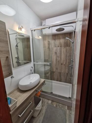 a bathroom with a glass shower and a sink at Villa Cvetić in Selce