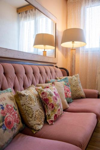 a couch with pillows on it with two lamps at Apartment Dadi in Cetinje