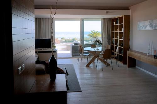 a living room with a table and a dining room at Residence Millecento in Cesenatico