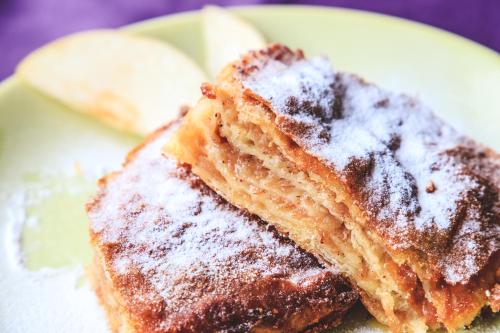 a piece of cake with powdered sugar on a plate at Art Hotel in Slavonski Brod