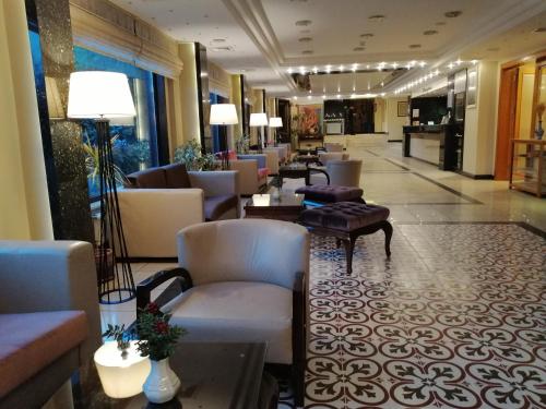 a lobby of a hotel with couches and tables at Iris Hotel in Canakkale
