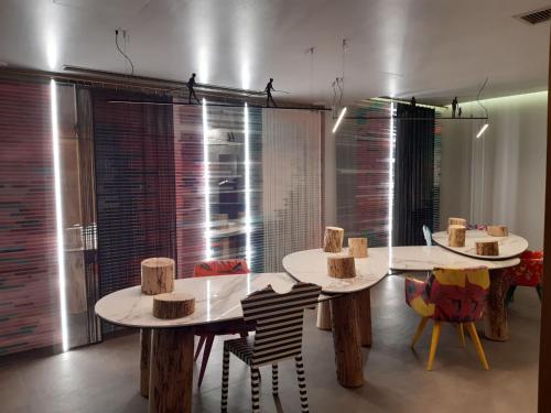 a room with two tables and chairs with hats on them at Marquise Suites - Adults Only in Fira