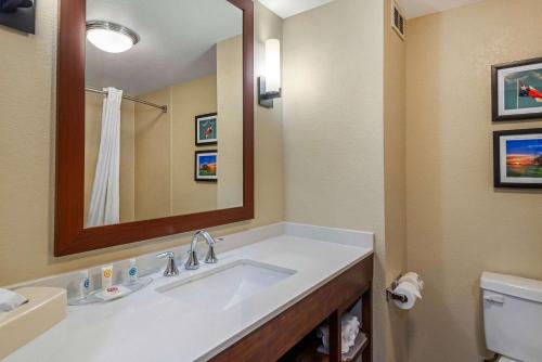 a bathroom with a sink and a mirror and a toilet at Comfort Inn & Suites in Big Spring
