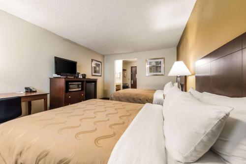 a hotel room with two beds and a flat screen tv at Quality Inn & Suites Lacey Olympia in Lacey