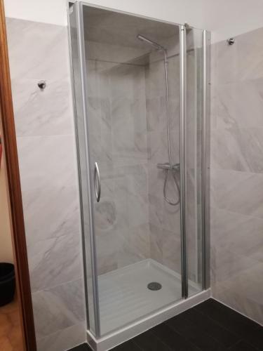 a shower with a glass door in a bathroom at Buarcos Beach House in Buarcos