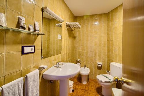 a bathroom with a sink and a toilet at O Son Do Mar in Sanxenxo