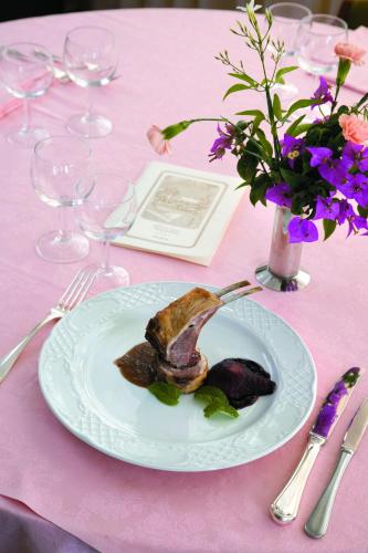 a plate of food on a pink table at Hotel Terme Alexander in Ischia