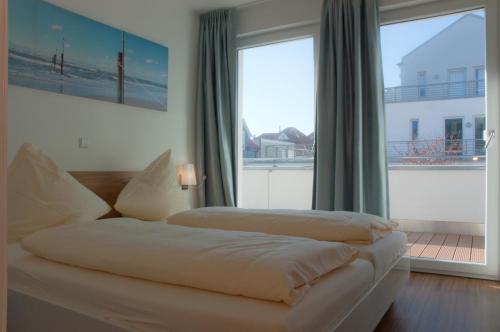 Giường trong phòng chung tại Apartments Boardinghaus Norderney