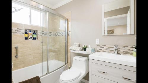 a bathroom with a shower and a toilet and a sink at Beautiful Studio in Redwood City