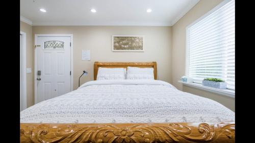 a large bed in a bedroom with a window at Beautiful Studio in Redwood City