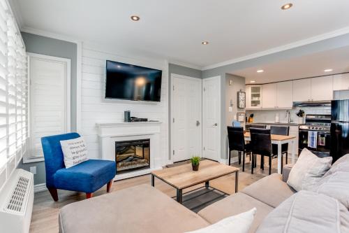 a living room with a couch and a fireplace at Blue Mountain Getaway at North Creek Resort King Bed in Blue Mountains