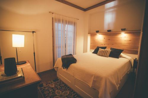 a bedroom with a large bed and a window at BayView House in Angra do Heroísmo