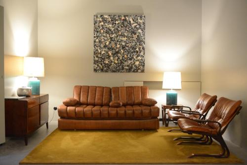 a living room with a couch and two chairs at Raw Culture Art & Lofts Bairro Alto in Lisbon