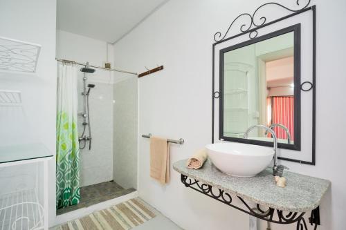 ein Badezimmer mit einem Waschbecken und einem Spiegel auf der Theke in der Unterkunft Cosy Studio #3 - Pereybere in Pereybere