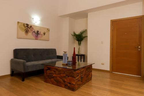 a living room with a couch and a table at Sybaris Suites & Residences in Juan Dolio