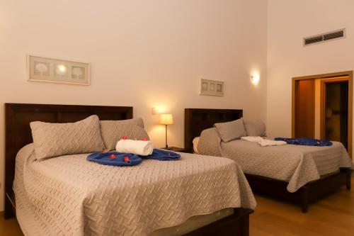 a bedroom with two beds with toys on them at Sybaris Suites & Residences in Juan Dolio