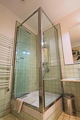 a shower with a glass door in a bathroom at Park View Bucharest in Bucharest