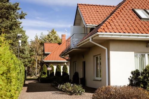 a house with red roofs and a driveway at Kalinowy Sen in Warsaw