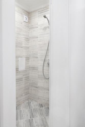 a shower in a bathroom with a shower curtain at Vip Luxury APARTMENT in Burgas