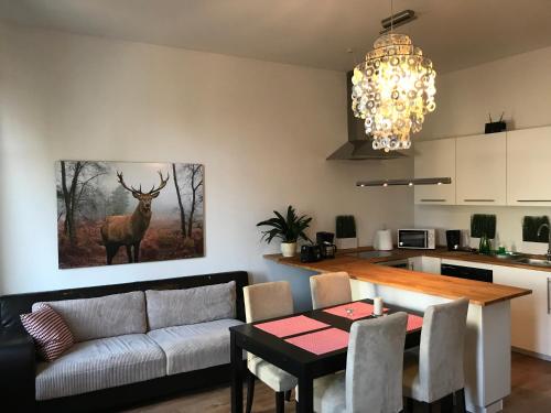 a living room with a couch and a table with a deer painting at Apartament Galicja in Chrzanów