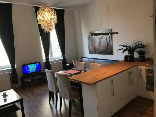 a kitchen with a table with chairs and a dining room at Apartament Galicja in Chrzanów