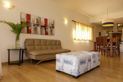a living room with a couch and a table at Sybaris Suites & Residences in Juan Dolio
