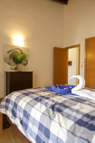 a bedroom with a bed with a toy swan on it at Sybaris Suites & Residences in Juan Dolio