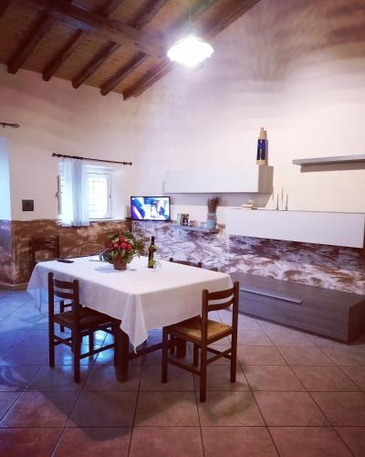 a dining room with a table and chairs and a kitchen at Villa Laura Apartment in Giardini Naxos