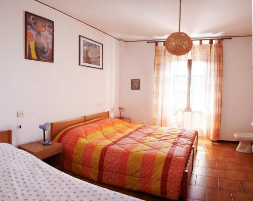 a bedroom with two beds and a window at Baita Bondella in Como