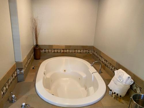 a bathroom with a large white tub in a room at Secrets Inn Lake Tahoe in South Lake Tahoe